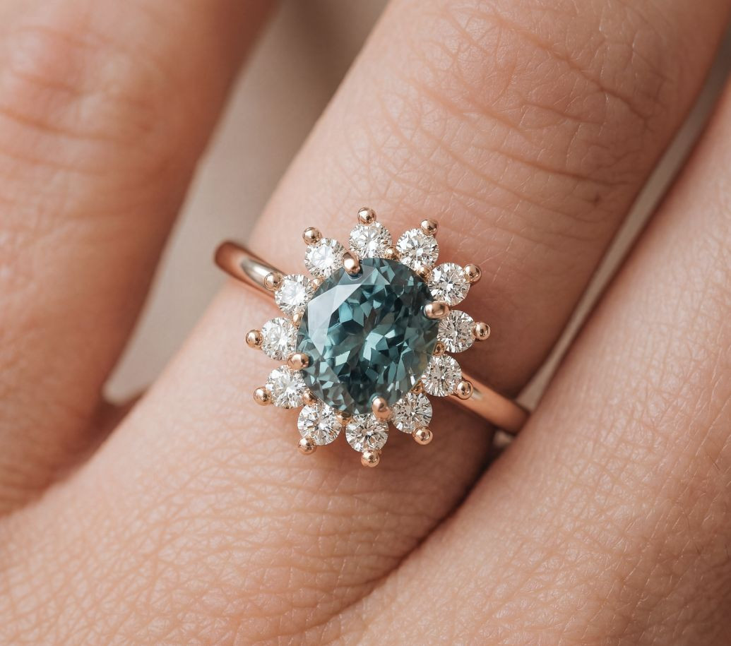 18k rose gold ring by LEPAGE, set with a grey spinel and surrounded by a halo of diamonds.